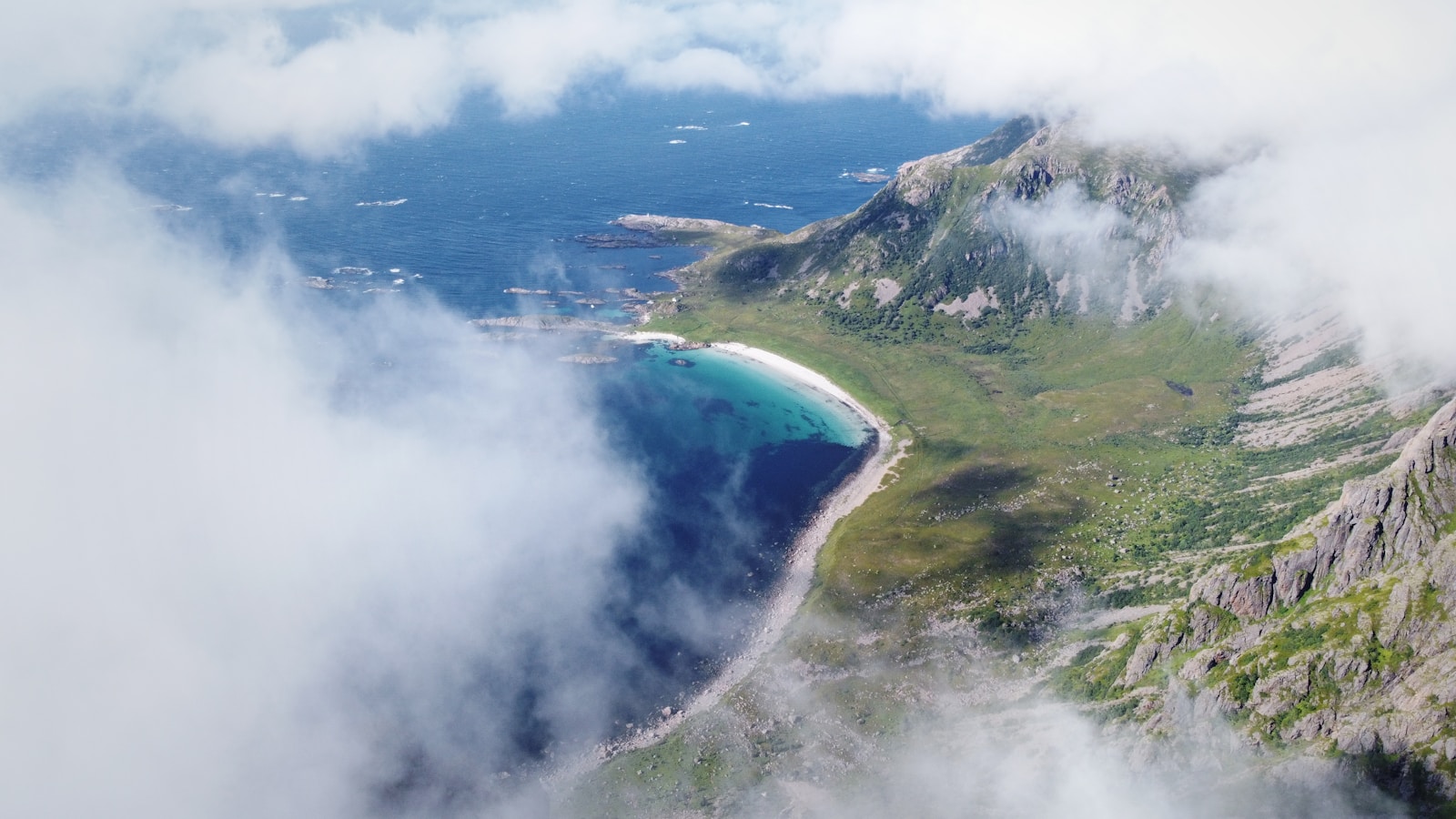 Photo by Gjermund Gustavsen Mountains, sea, and clouds create a scenic view.
