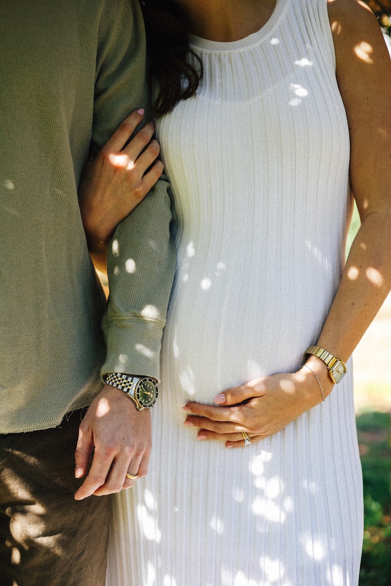Expecting parents embrace, celebrating pregnancy together.